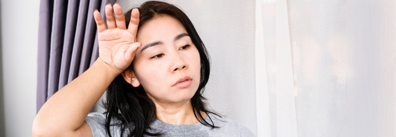 hot sleeper wiping sweat from brow