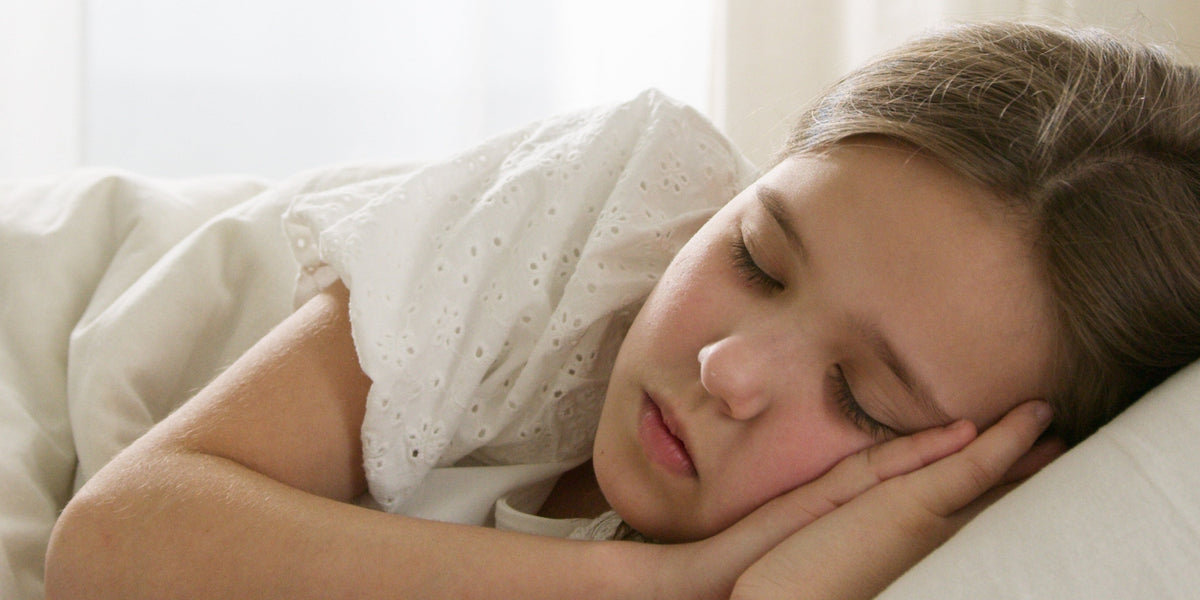 little girl sleeping in bed