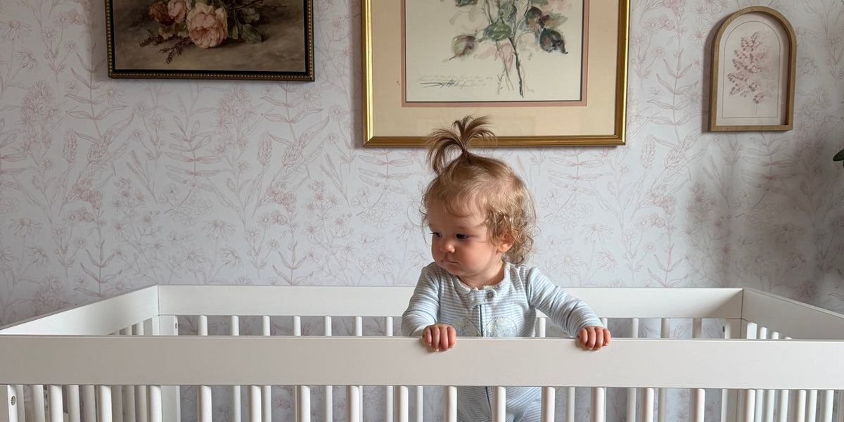 12-month old baby standing in crib
