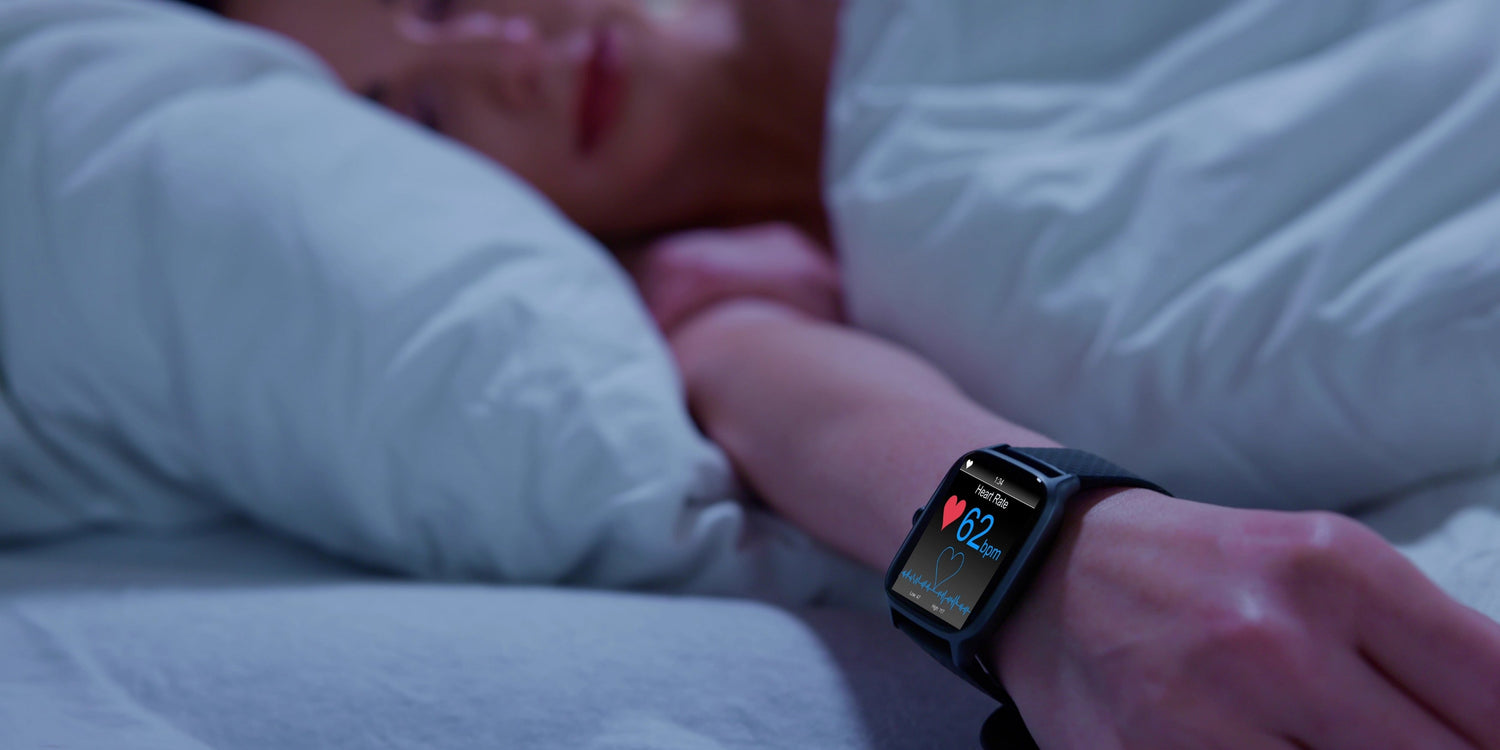 Person wearing sleep tracker in bed