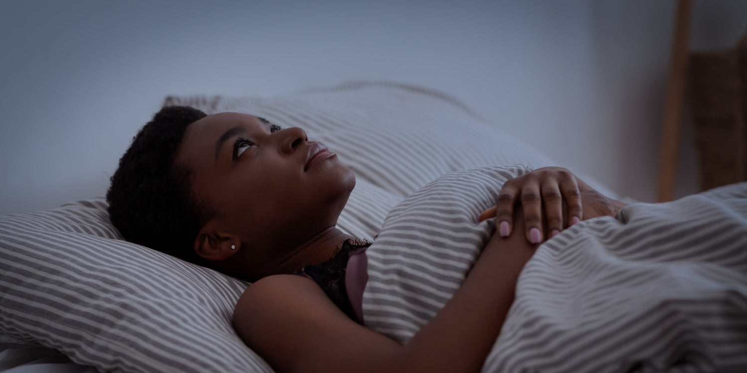 Woman who can't sleep, laying awake in bed