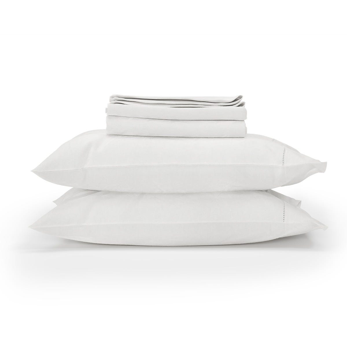 Stack of white folded bed sheets and pillowcases on a white background #color_arctic snow