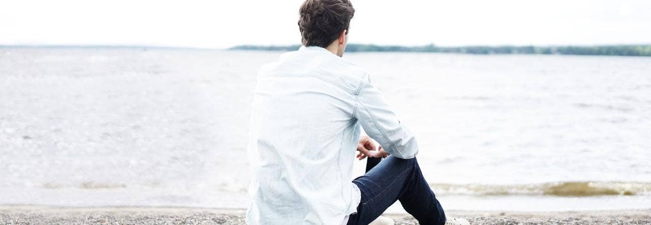 Man sitting alone on beach