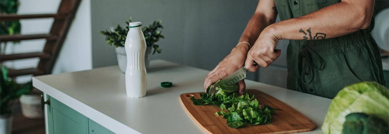Woman chopping organic lettuce for a healthy lifestyle