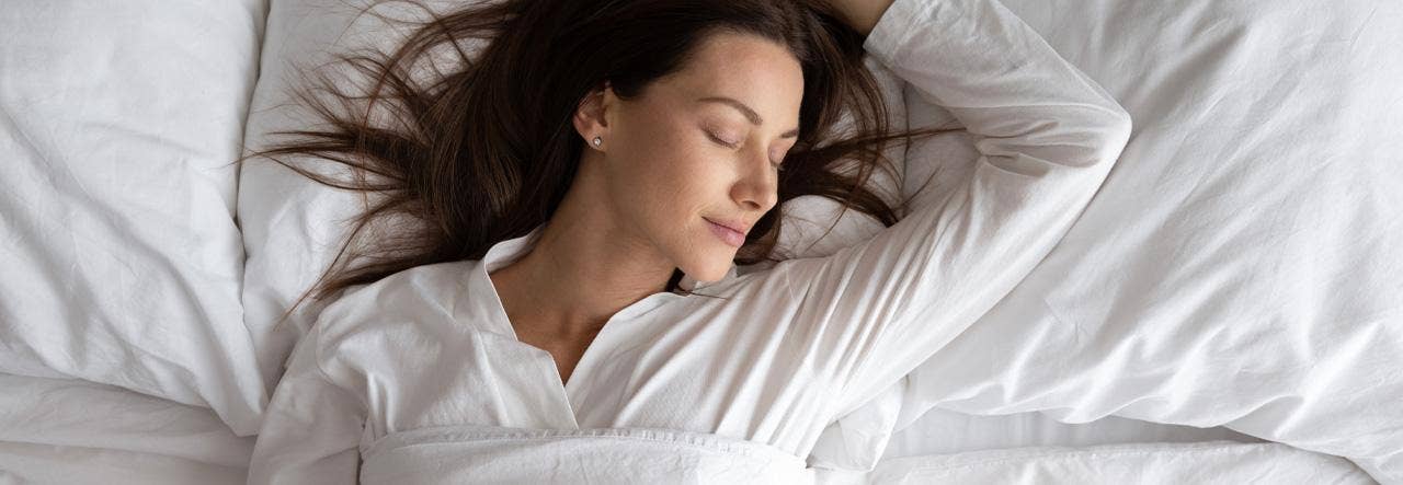 Woman sleeping peacefully on fresh organic bedding