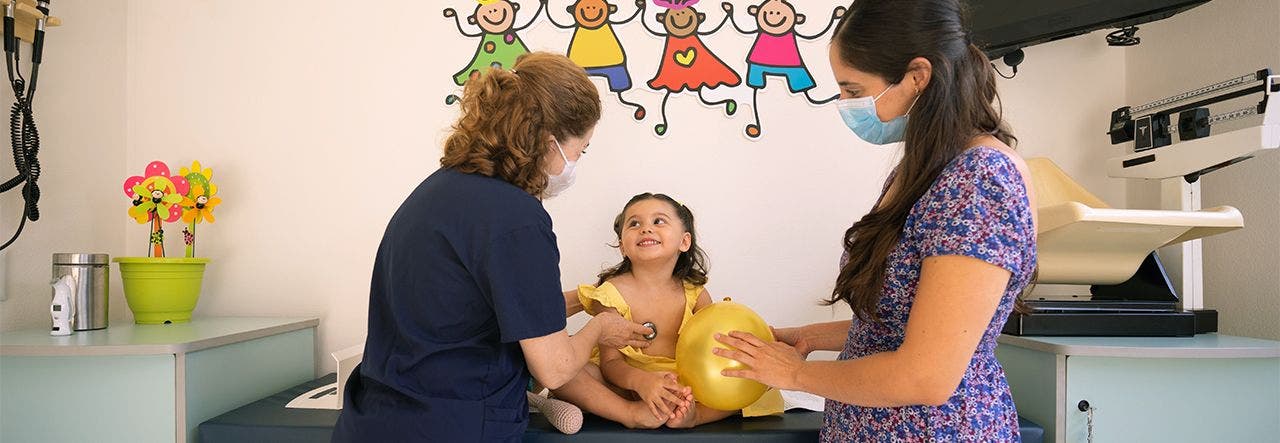 Mom and child at the pediatrician's for the annual wellness visit 