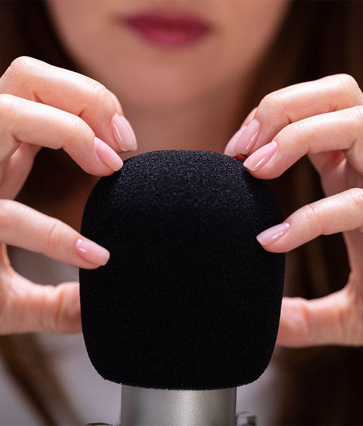 woman scratching microphone for asmr