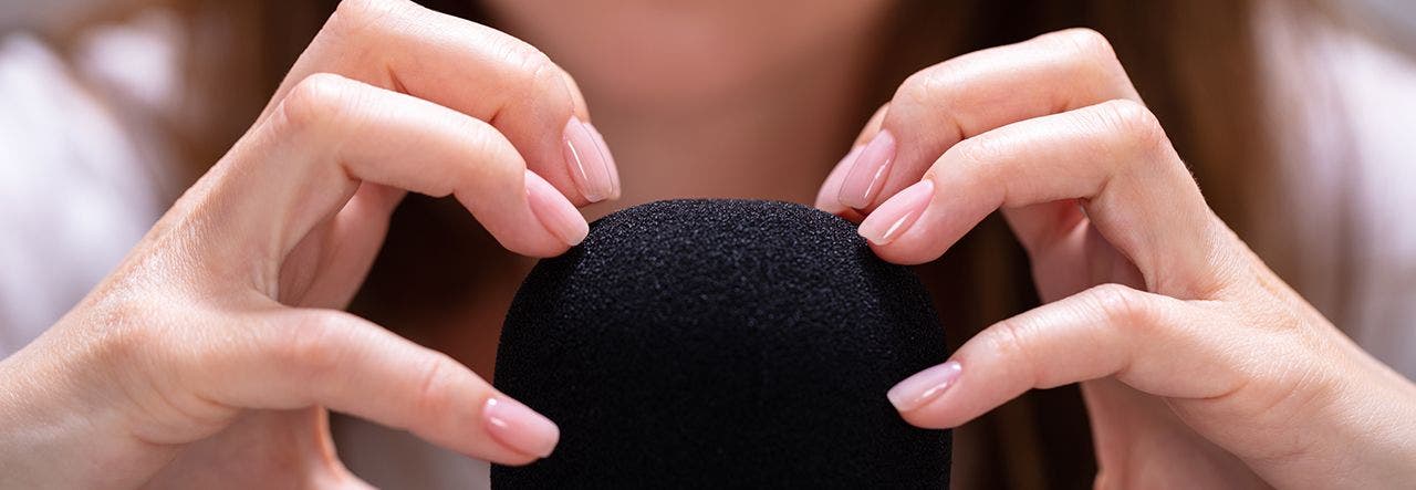 woman scratching microphone for asmr
