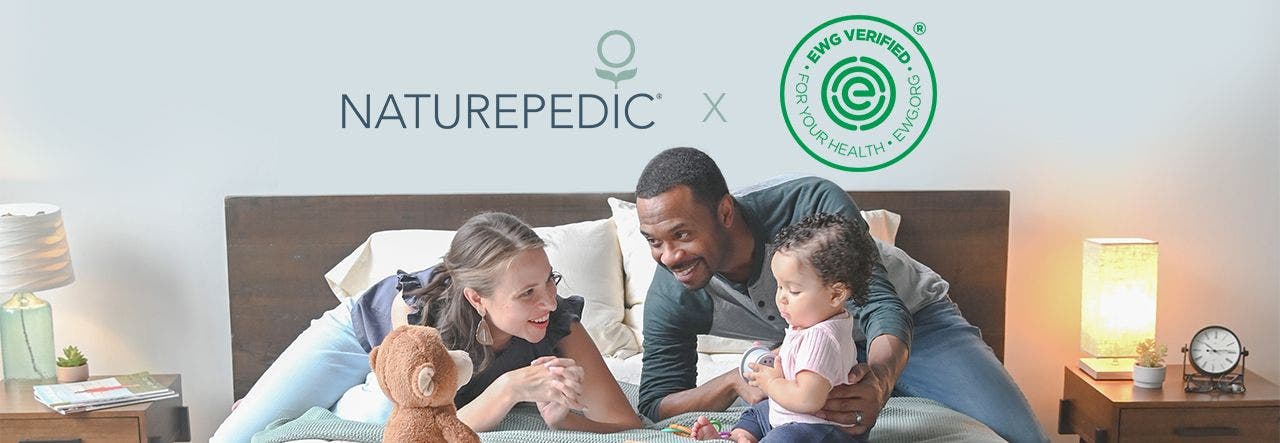 Family of four relaxing on their EWG VERIFIED Naturepedic mattress