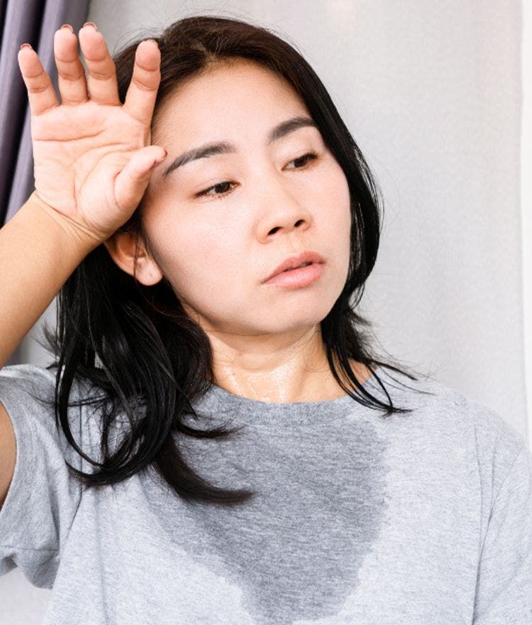 hot sleeper wiping sweat from brow