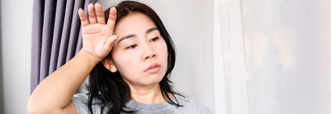 hot sleeper wiping sweat from brow