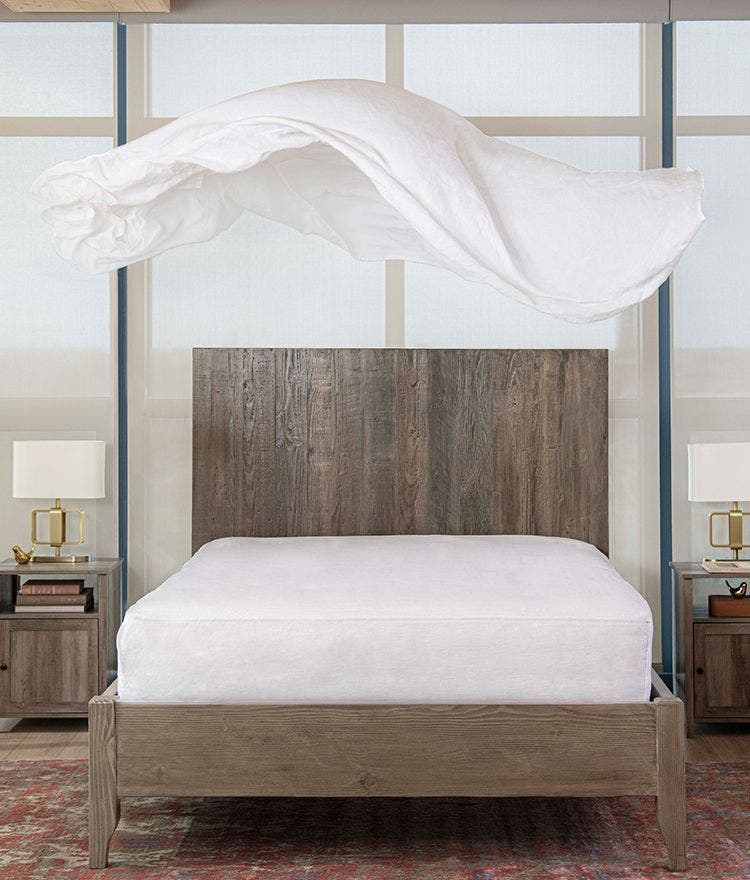 linen sheets floating above bed