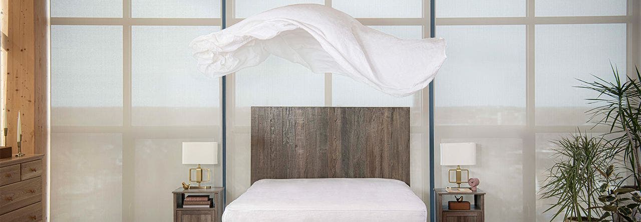 linen sheets floating above bed