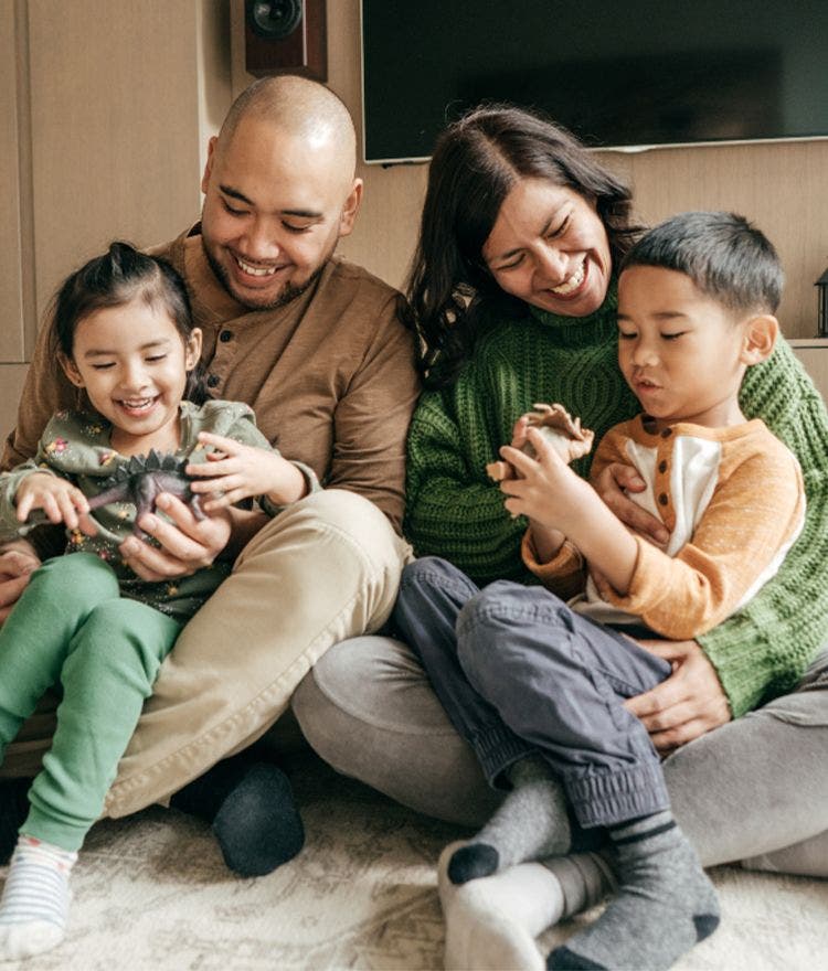 portrait of a family of four smiling 