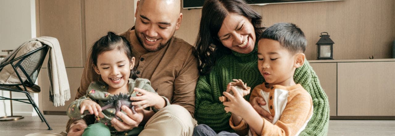 portrait of a family of four smiling 