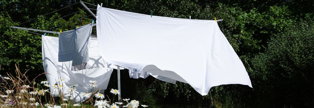 white bedsheets hanging on a clothesline