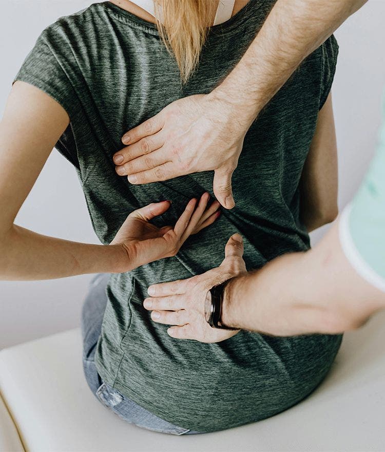 chiropractor adjusting woman's back