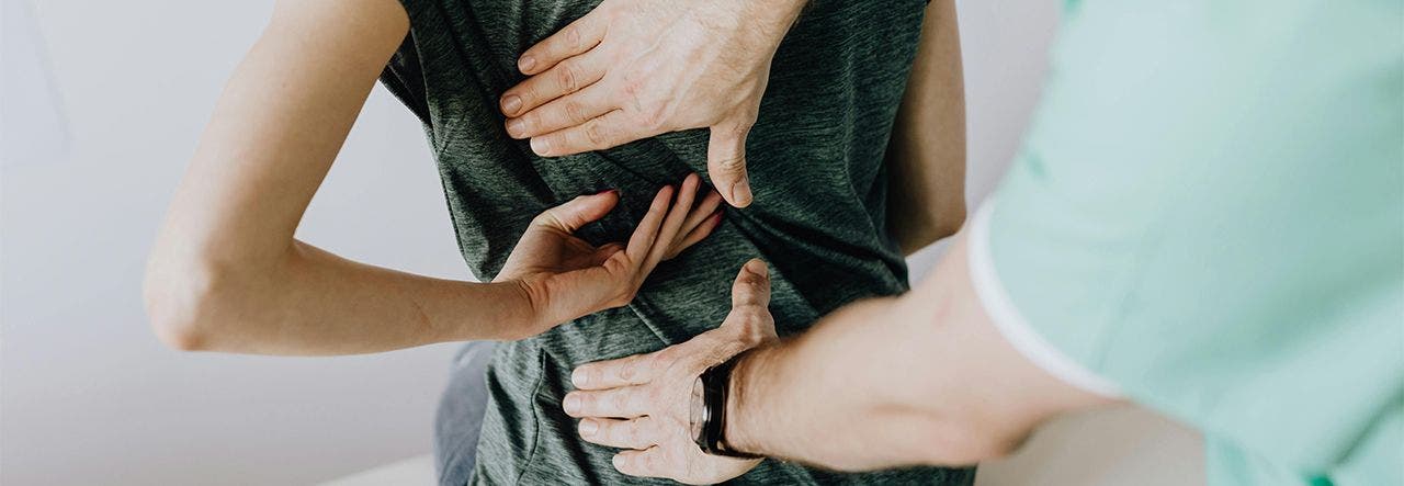chiropractor adjusting woman's back