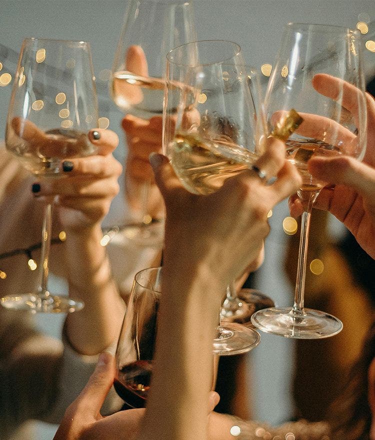 friends clinking glasses of champagne to cheer on the new year