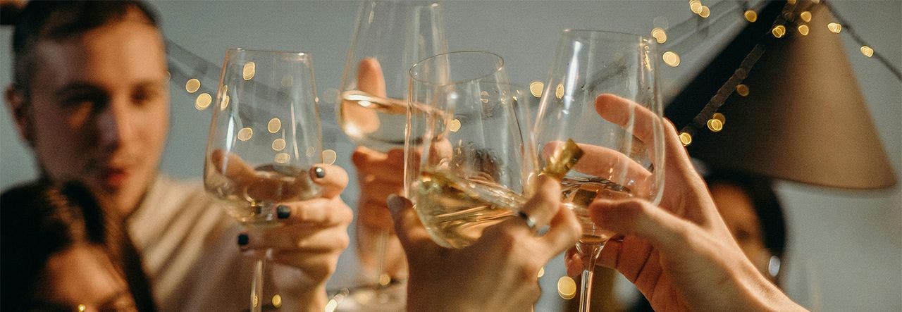 friends clinking glasses of champagne to cheer on the new year