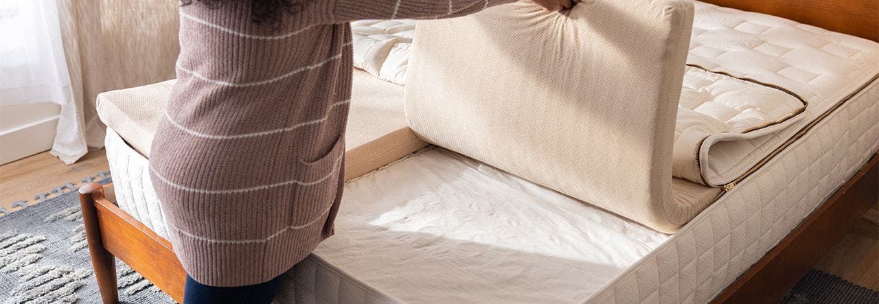 couple holding organic latex layers of their eos pillowtop customizable organic mattress