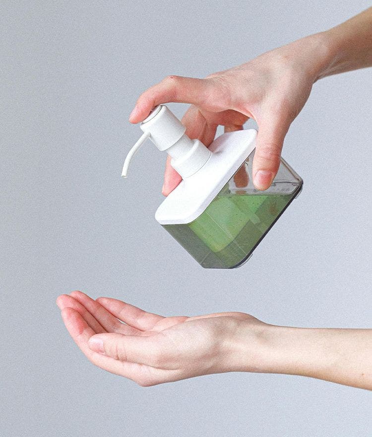 Green soap being pumped into hand