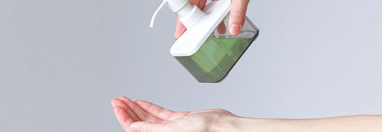 Green soap being pumped into hand