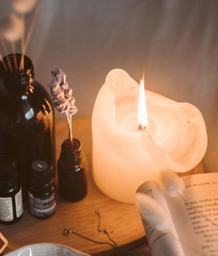 winter cozy bedside table with candles essentials oils book