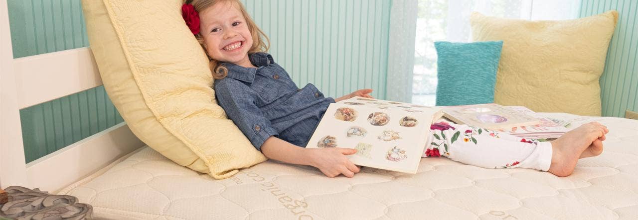 girl on naturepedic 2-in-1 organic kids mattress