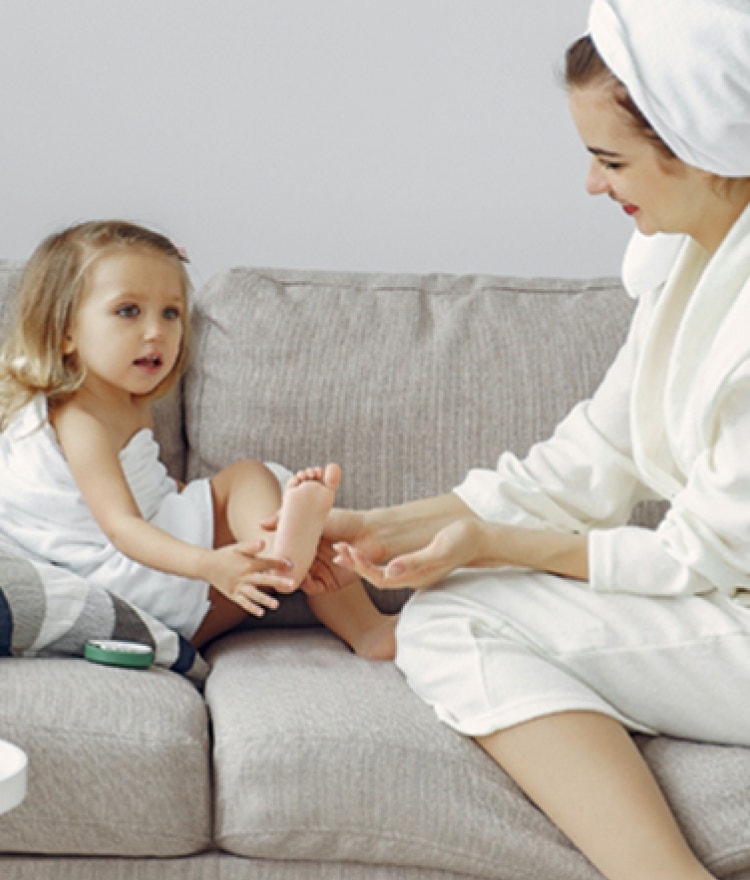 little girl and adult sitting on couch