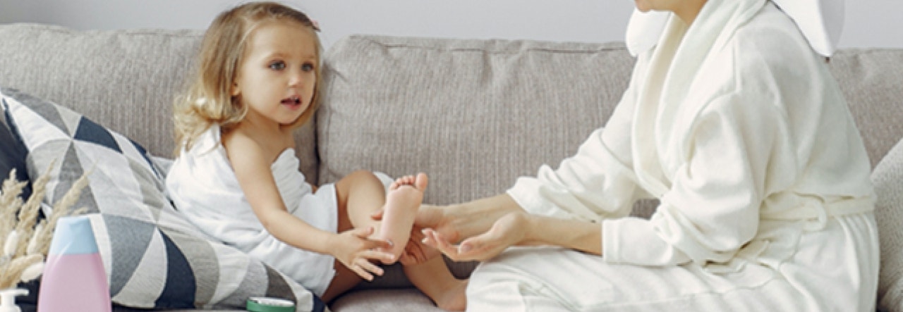 little girl and adult sitting on couch