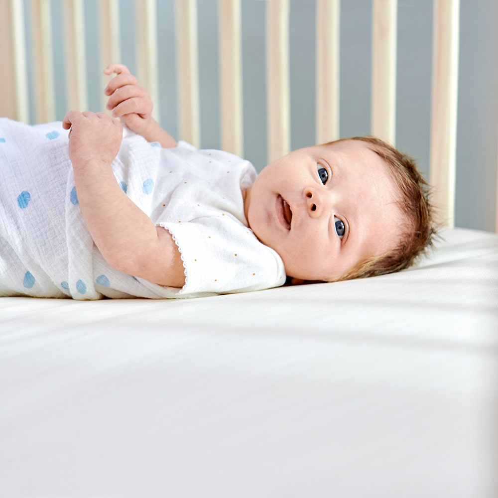 Woman laying in bed with body pillow