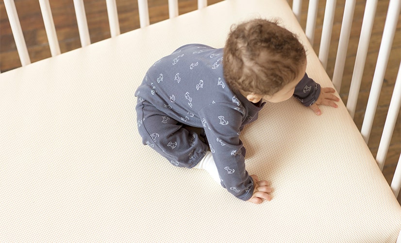 baby crawling in crib