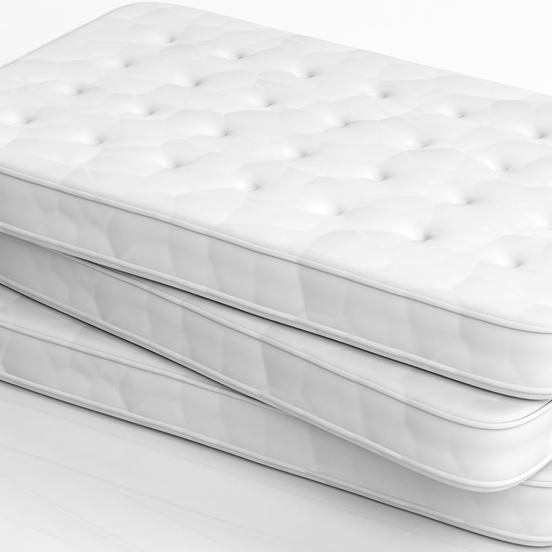 Stack of three conventional twin mattresses