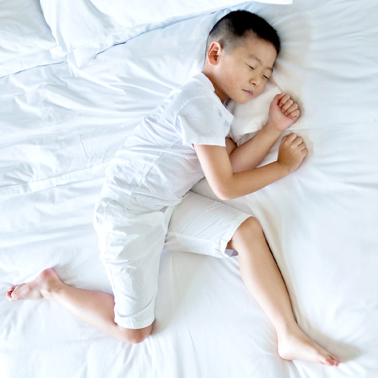 Boy sleeping on mattress