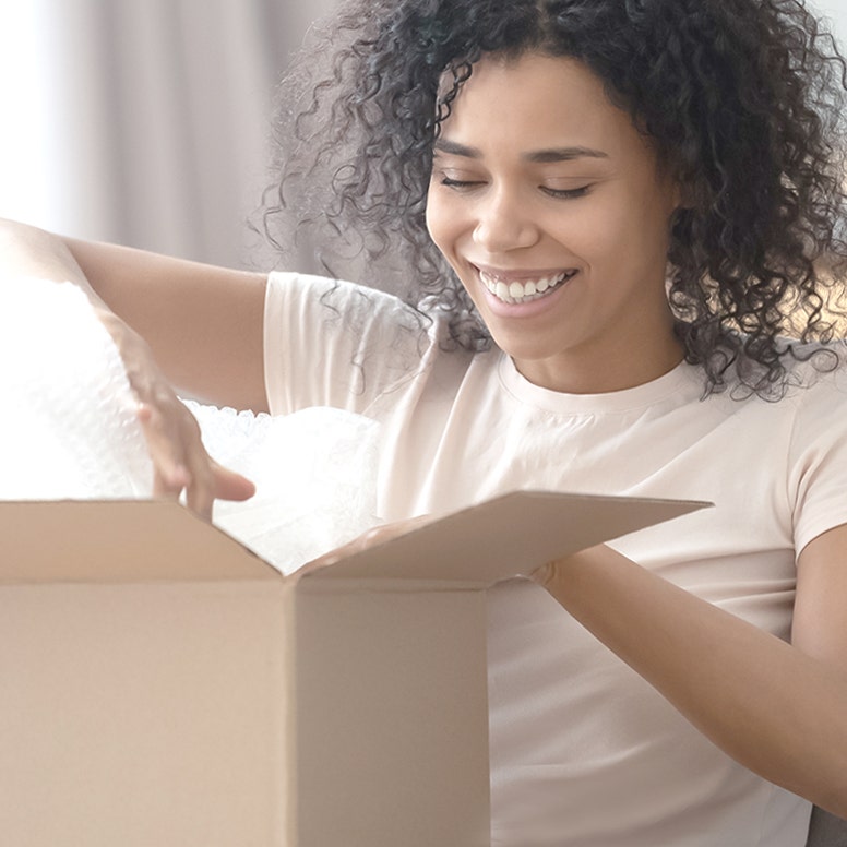 Woman opening shipping box