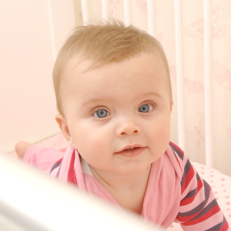 Baby girl in crib looking up