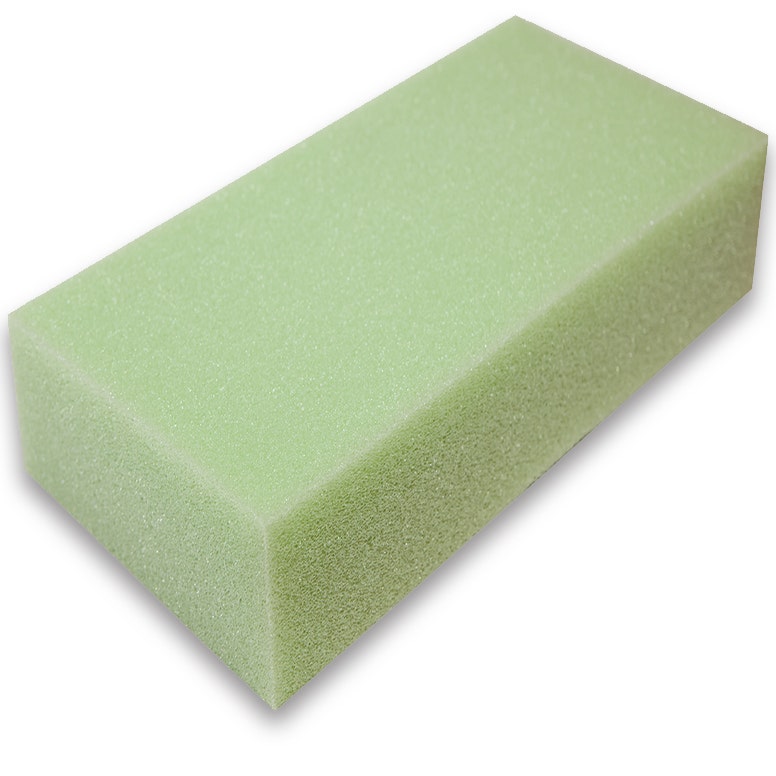 Block of green colored polyurethane foam