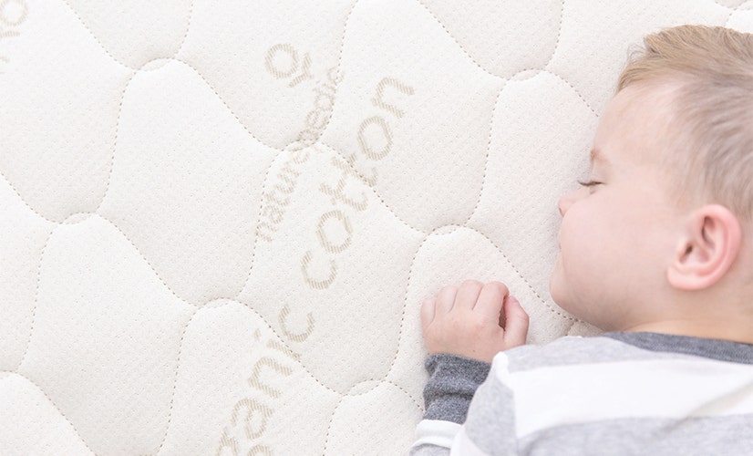 Close-up of child sleeping on mattress