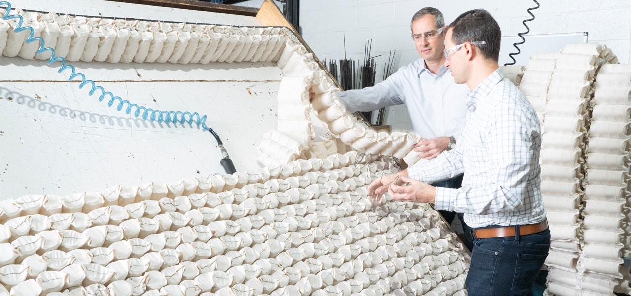 Naturepedic co-founders Jeff and Jason Cik assessing wrapped coils in the factory