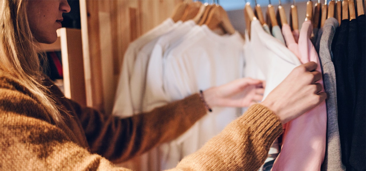 Woman looking through clothing rack in a store