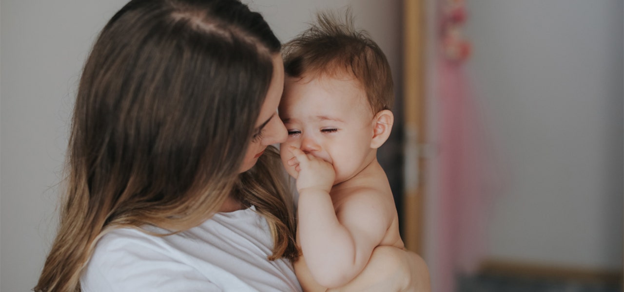 Mother comforting her 4-month-old baby