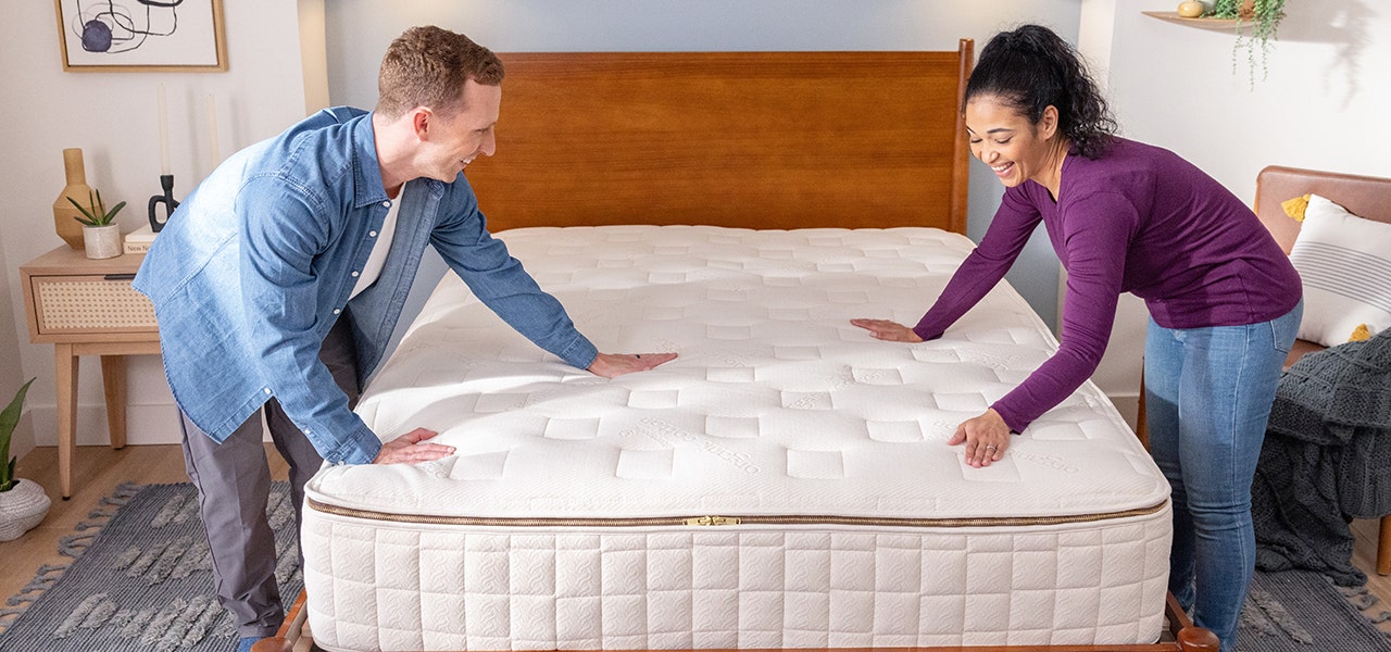 Man and woman setting up their EOS customizable organic mattress