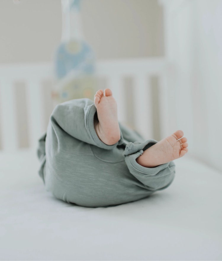 Baby lying on their back on an organic mattress