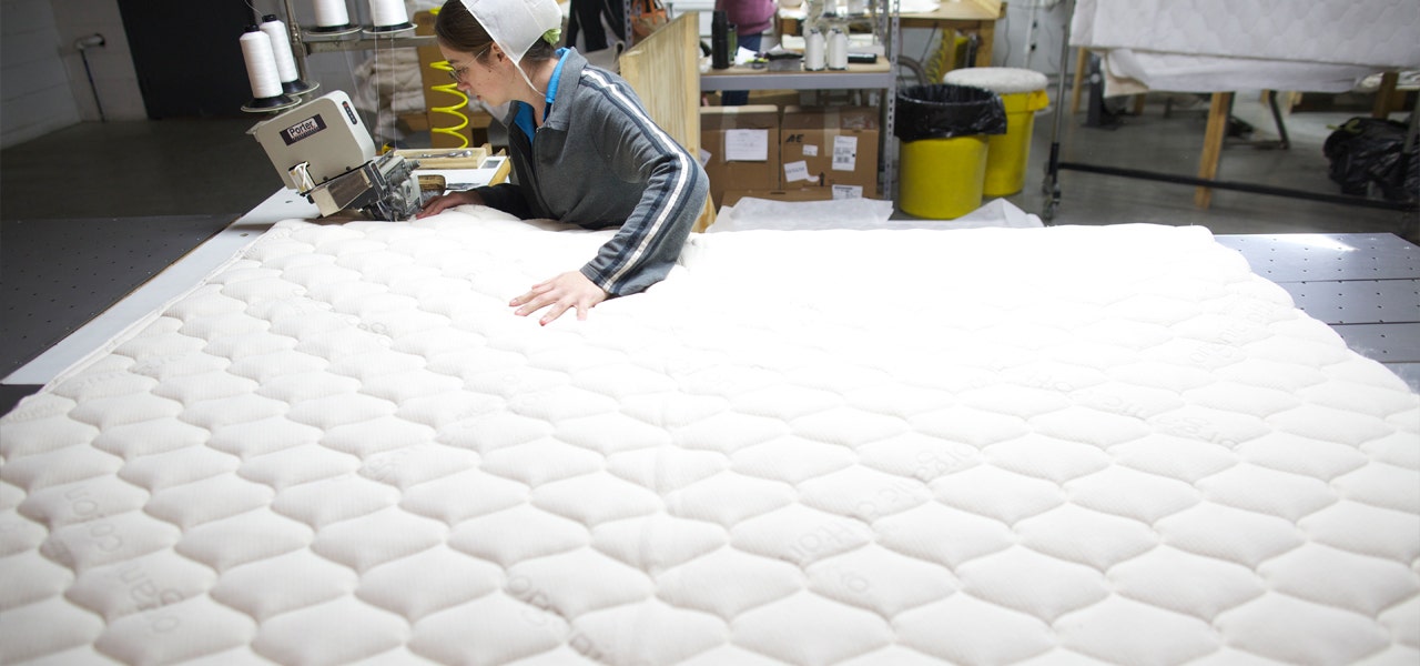 Woman sewing organic quilting in the Naturepedic factory