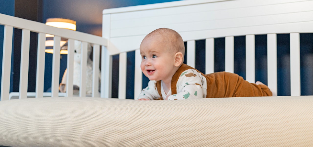 Baby enjoying tummy time on a Naturepedic Breathable Organic Mattress