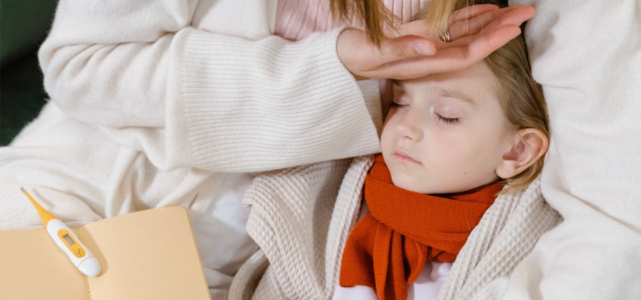 Mother feeling her child's forehead to check for a fever