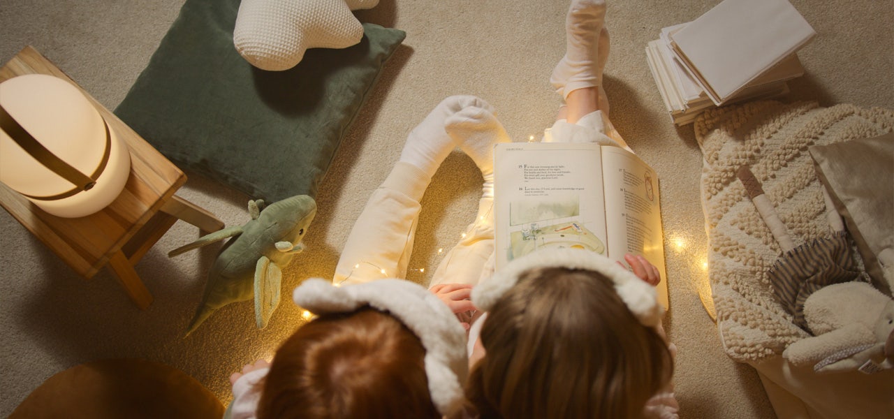 Two children in PJs, reading bedtime stories together