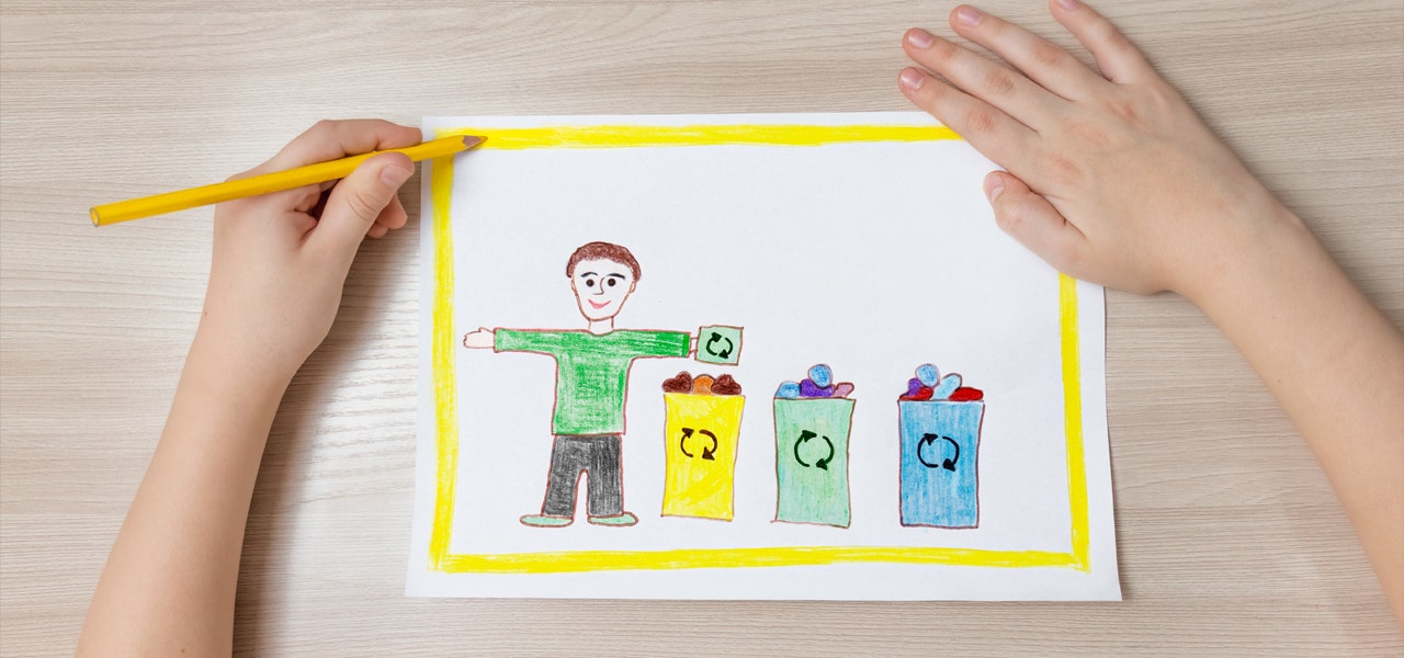 Child drawing a colorful picture of a person recycling