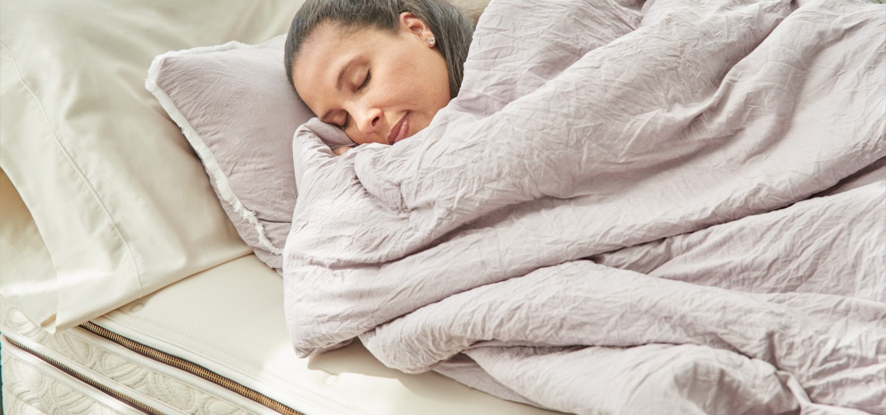 Woman sleeping on a new mattress during the mattress trial period